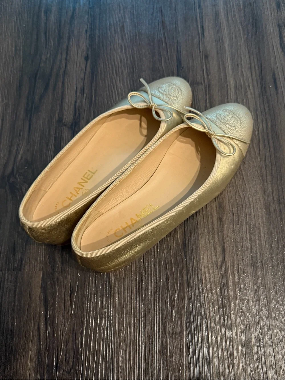 CHANEL Metallic Gold Leather Ballet Flats with Bow Accent